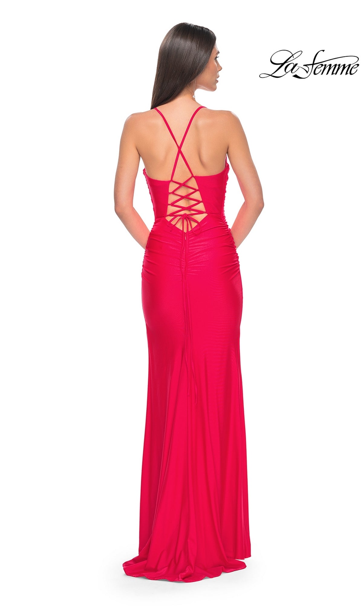 A woman models the La Femme Corset-Back Long Prom Dress 31131, a fitted, floor-length gown in bright red with a crisscross lace-up open back. She faces away from the camera, highlighting the elegant corset-inspired design.